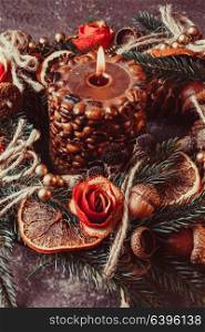 Christmas aromatic eco wreath decorated tangerine peel roses with coffee burning candle. Christmas aromatic burning candle