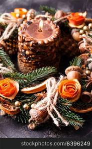 Christmas aromatic eco wreath decorated tangerine peel roses with coffee burning candle. Christmas aromatic burning candle