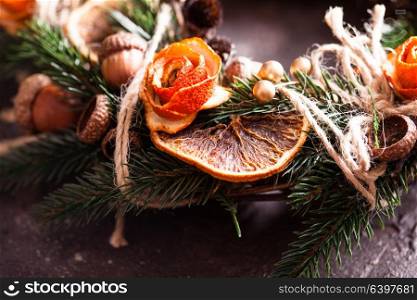 Christmas aromatic eco wreath with dry orange and anise stars, decorated tangerine peel roses, closeup details. Christmas aromatic eco wreath