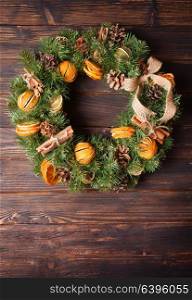 Christmas aromatic eco wreath with dry orange and cinnamon sticks, closeup details. Christmas aromatic wreath