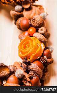 Christmas aromatic wreath from natural components with tangerine roses. Mulled wine style. Christmas aromatic wreath