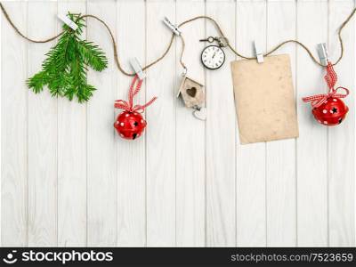 Christmas arrangement with greeting card. Christmas tree branches on bright wooden background