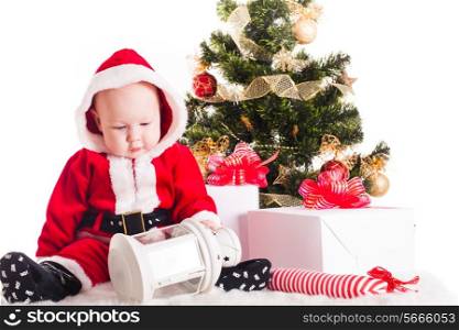 Christmas baby under the New Years tree with gifts
