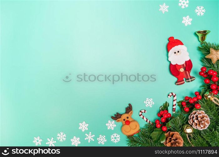 Christmas background concept. Top view of Christmas decoration, Santa Claus and reindeer with red gift box on green background