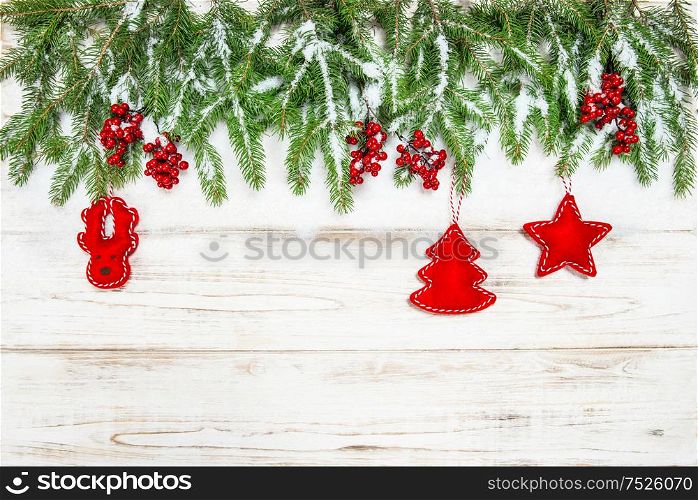 Christmas background. Evergreen tree branch with red berries and decoration