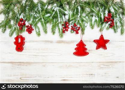 Christmas background. Evergreen tree branch with red berries and decoration