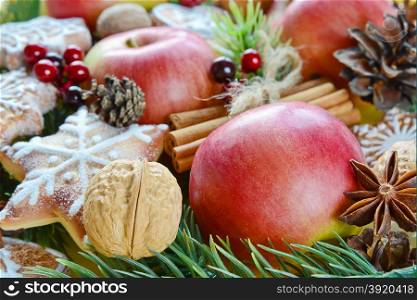 Christmas background from the red apples, cookies and spices