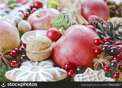 Christmas background from the red apples, cookies and spices