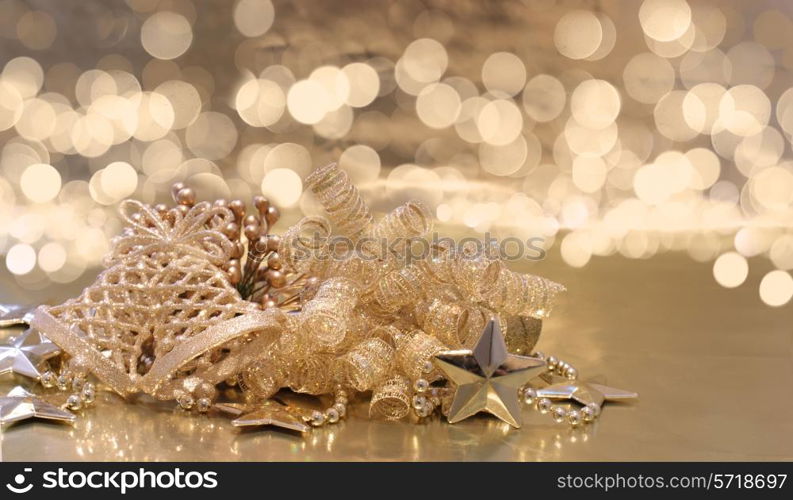 Christmas background of golden decorations on a background of defocussed lights