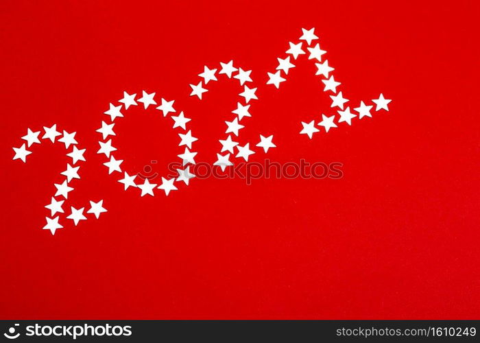 christmas background. on a red background an inscription with asterisks 2021  