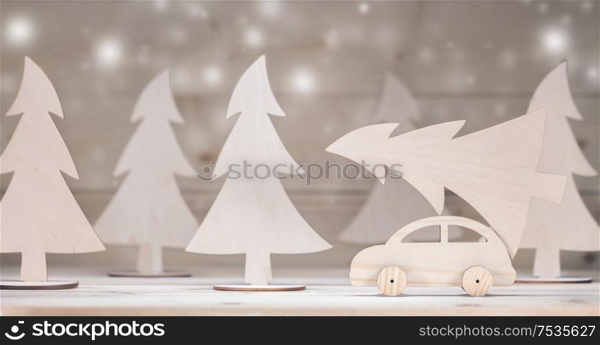 Christmas background. Toy handmade wooden car with christmas tree. Merry Christmas and Happy New Year background. Toy car with christmas tree
