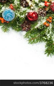 Christmas background with balls and decorations and snow, holly berry, cones isolated on white