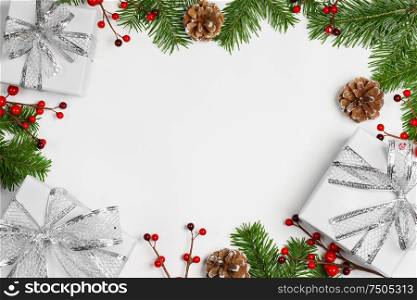 Christmas background with balls and decorations of holly berry, cones, gifts, balls on white. Christmas background with decorations
