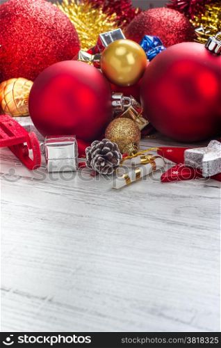 Christmas background with balls and decorations over wooden table