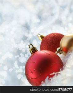 Christmas background with baubles nestled in snow