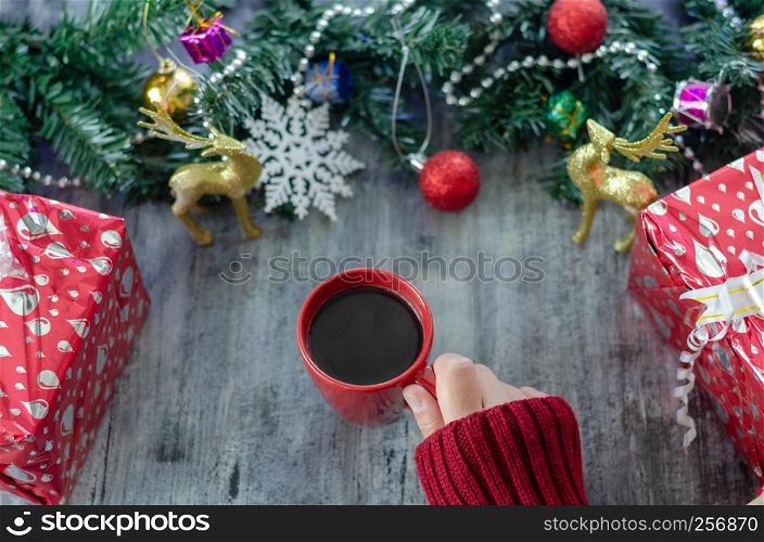 Christmas background with decorations and gift boxes on wooden board.