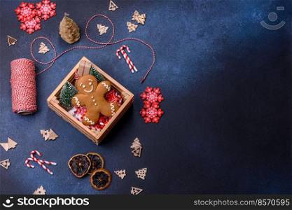 Christmas background with decorations. New Year symbol - decorative fir tree. Christmas composition made of christmas decoration on a dark background.
