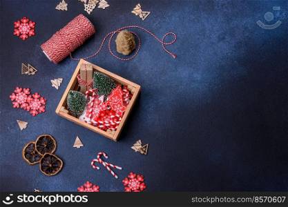Christmas background with decorations. New Year symbol - decorative fir tree. Christmas composition made of christmas decoration on a dark background.