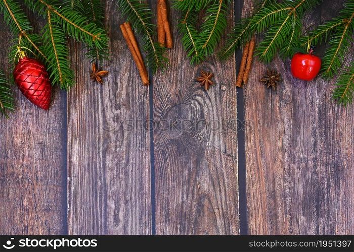 Christmas background with decorations on a brown wooden background. Flat lay, top view with copy space.