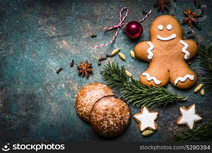 Christmas background with festive decoration, cookies, gingerbread man and fir branches top view, place for text