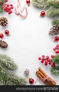 Christmas background with fir tree and decor on white background. Top view with copy space