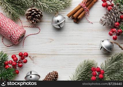 Christmas background with fir tree and decor on white wooden background. Top view with copy space