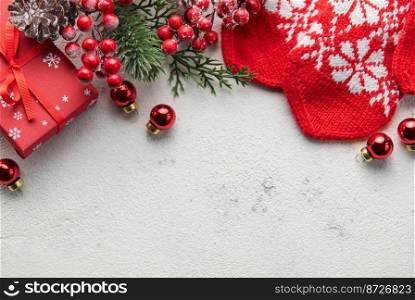 Christmas background with fir tree, red mittens and decor on concrete background. Top view with copy space