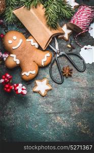 Christmas background with Gingerbread man cookie , festive gift boxen and scissors, top view, place for text