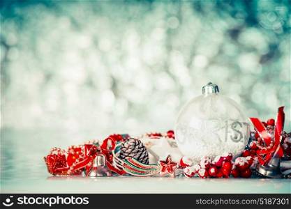 Christmas background with glass balls and red festive decoration at winter bokeh background, front view
