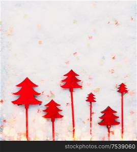 Christmas background with red Christmas trees on snow . Creative winter holiday concept. Flat lay
