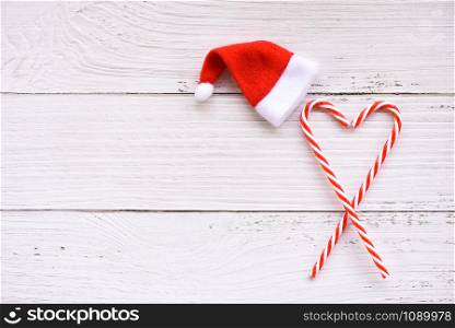 Christmas background with santa hat and candy cane decoration holiday festive Happy New Year object , top view copy space