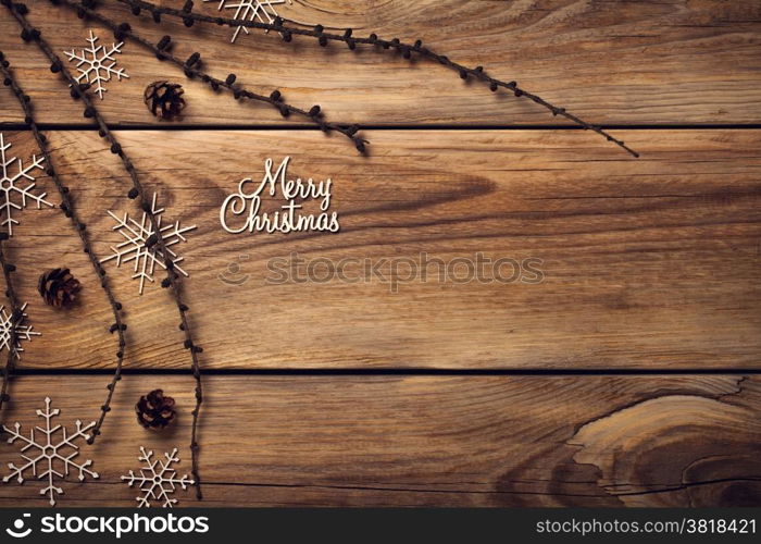 Christmas background with snowflakes and cones on wooden table. Copy space. Top view&#xA;