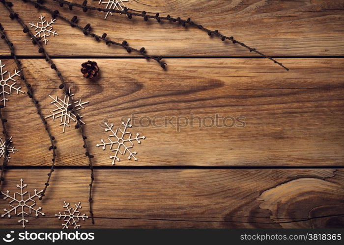 Christmas background with snowflakes on wooden table. Copy space. Top view