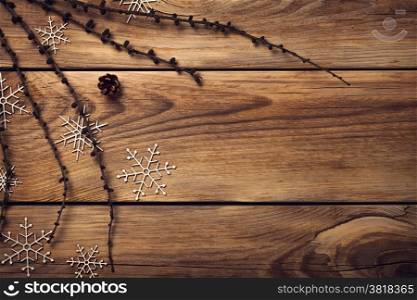 Christmas background with snowflakes on wooden table. Copy space. Top view