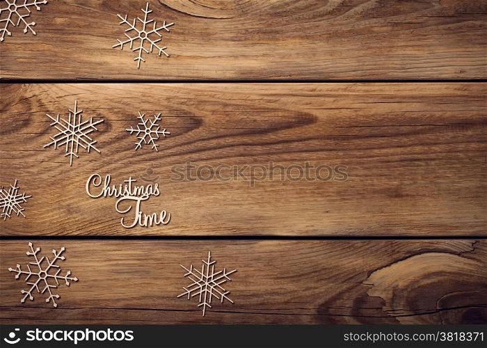 Christmas background with snowflakes on wooden table. Copy space. Top view