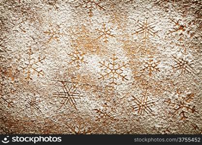 Christmas background with snowflakes. Snowflake pattern made ??of icing sugar on wooden table. Top view
