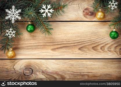 Christmas background with spruce tree, snowflakes and christmas balls on table. Copy space. Top view
