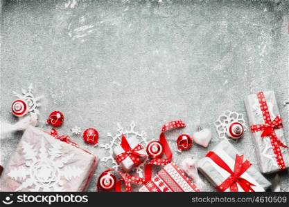 Christmas background with white red gift wrap ,festive holiday decorations and handmade paper snowflakes, top view, border