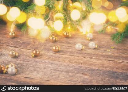 christmas background - wooden table with defocused lights and glass decorationd, retro toned