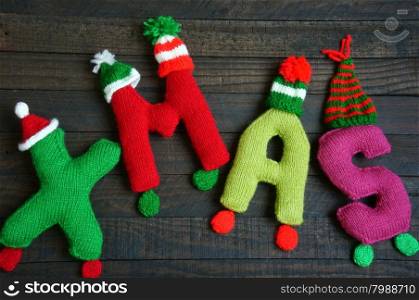Christmas background, Xmas alphabet handmade by knitted, amazing ornament for noel as letter, gift, hat knit from red and green yarn, so amazing hand made product for winter holiday