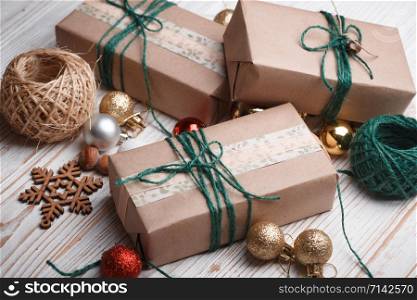 Christmas backgrounds. Gifts and Christmas decor on the wooden background.