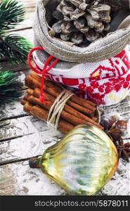 Christmas bag. Christmas bag with pine cones on wooden snowy background