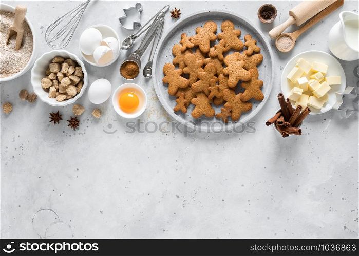Christmas baking culinary background. Xmas gingerbread on kitchen table and ingredients for cooking festive cookies. New Year holiday decorations