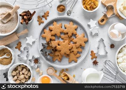 Christmas baking culinary background. Xmas gingerbread on kitchen table and ingredients for cooking festive cookies. New Year holiday decorations