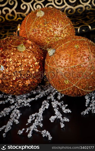 Christmas ball baubles with orange, silver and gold decoration.