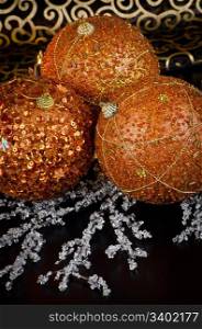 Christmas ball baubles with orange, silver and gold decoration.