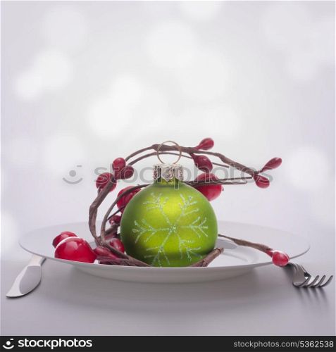 Christmas ball decoration on plate. Feast concept.