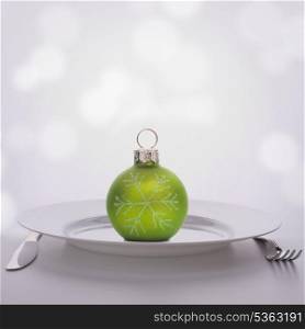 Christmas ball decoration on plate. Feast concept.