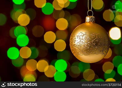 Christmas ball hanging defocused sparkling lights on the background