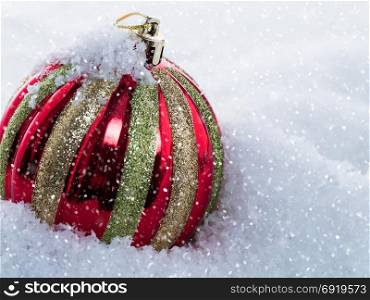 Christmas ball on snow. Close-up. New Year holiday background